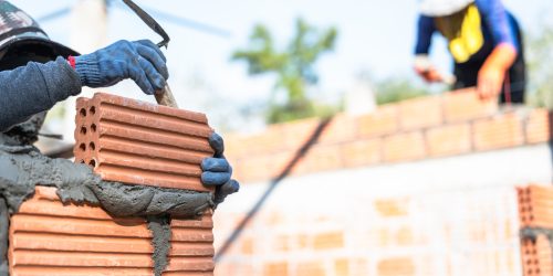 Hand worker masonry installation brick wall on construction site Hand worker masonry installation brick wall on construction site